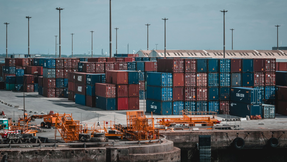 Cargo containers stacked at port – Tangen logistics hub.
