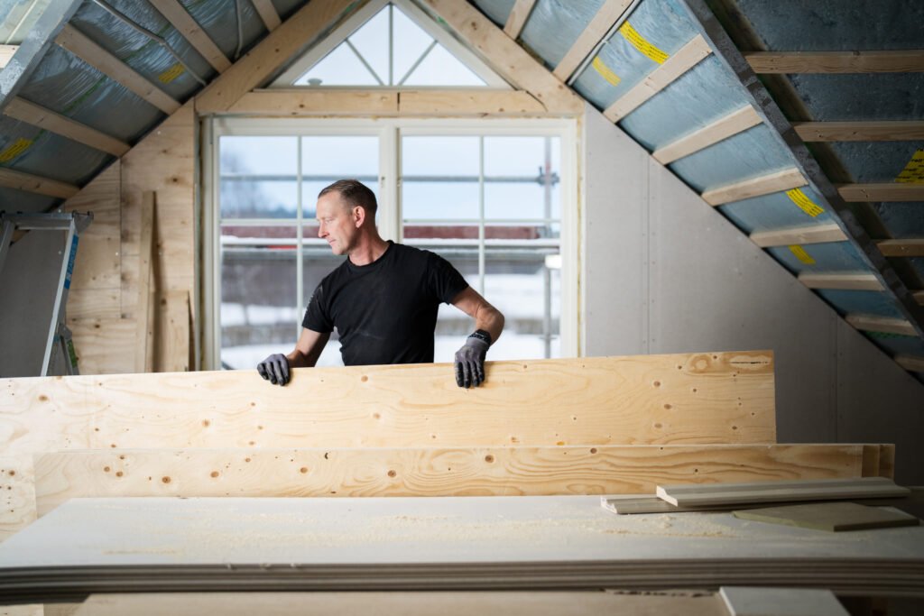Worker constructing wooden frame – Tangen sustainable building.