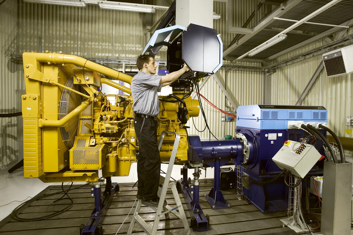 Workers in factory with machinery – Tangen production site.