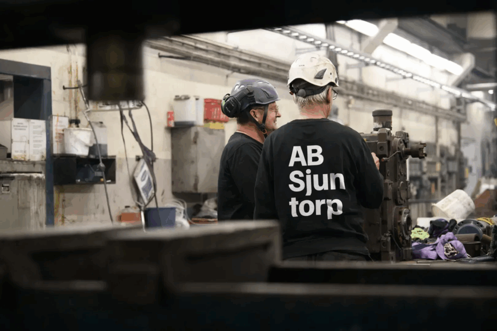 Worker operating machinery indoors – Tangen manufacturing site.