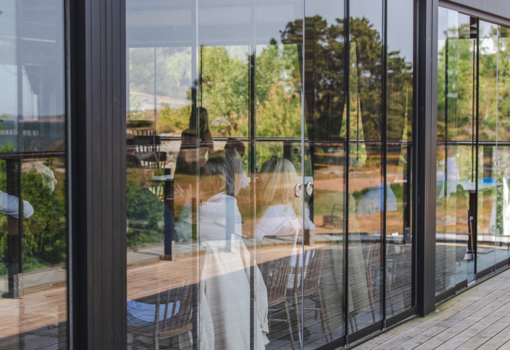 Glass building with people inside.