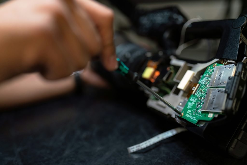 Close-up of hands assembling electronic hardware.
