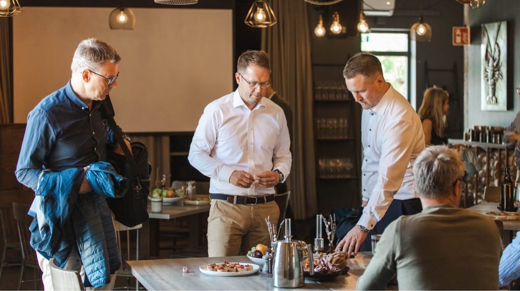 People preparing food together in a restaurant or kitchen setting.